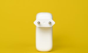white plastic bottle on yellow surface
